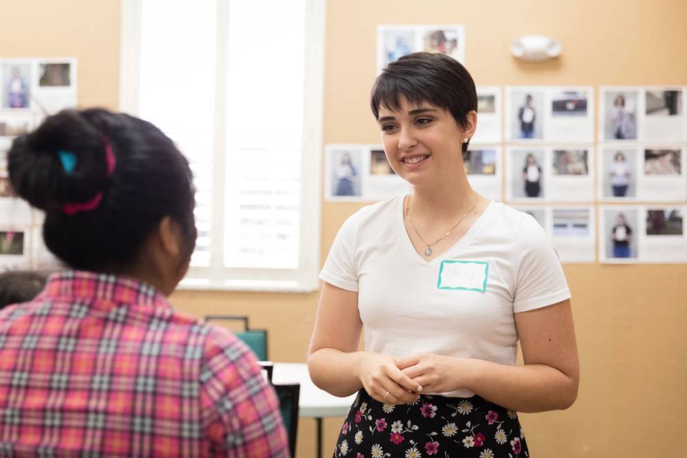 A student interviews a migrant farmworker.