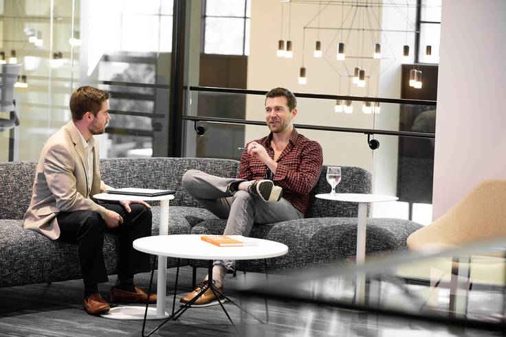 A Rollins student meets with his mentor in Kathleen W. Rollins Hall.