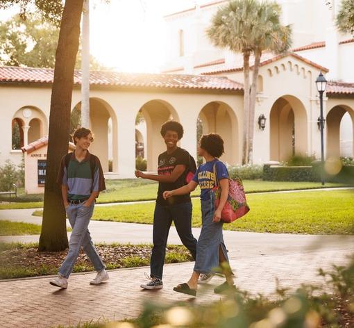 Three students walking through campus.