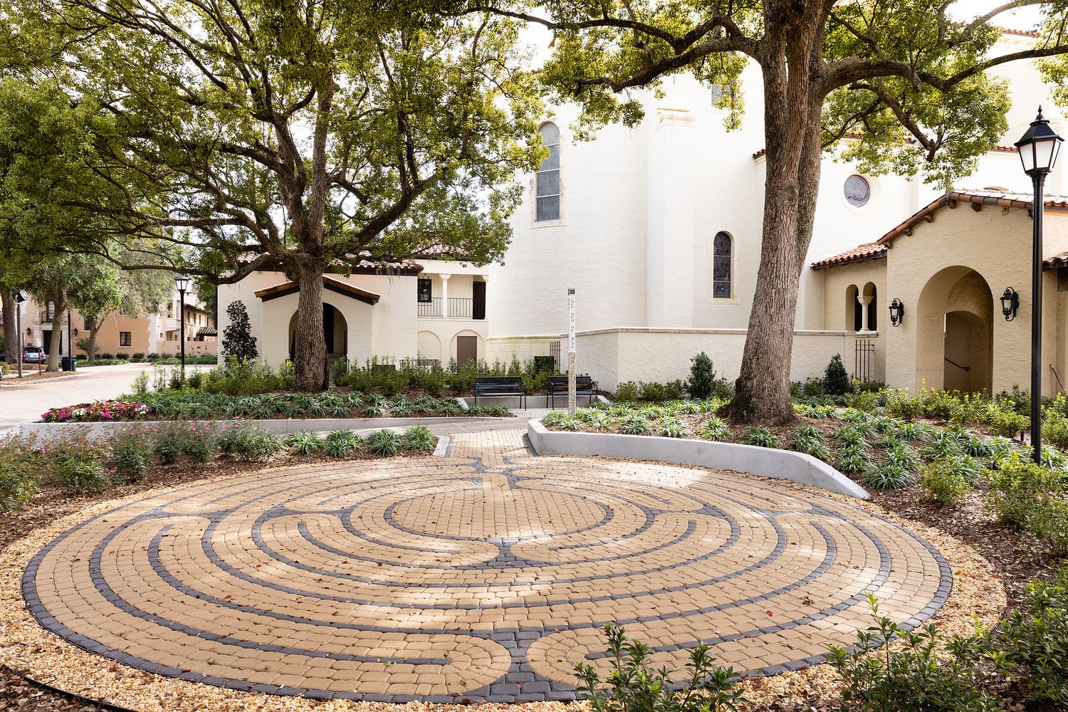 Circular brick pathway set inside garden. 