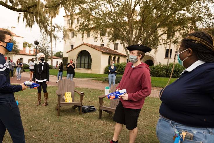Students in costumes hold nerf guns