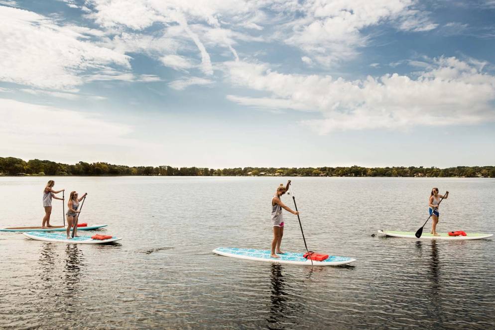 Students paddlebaord on Lake Virginia