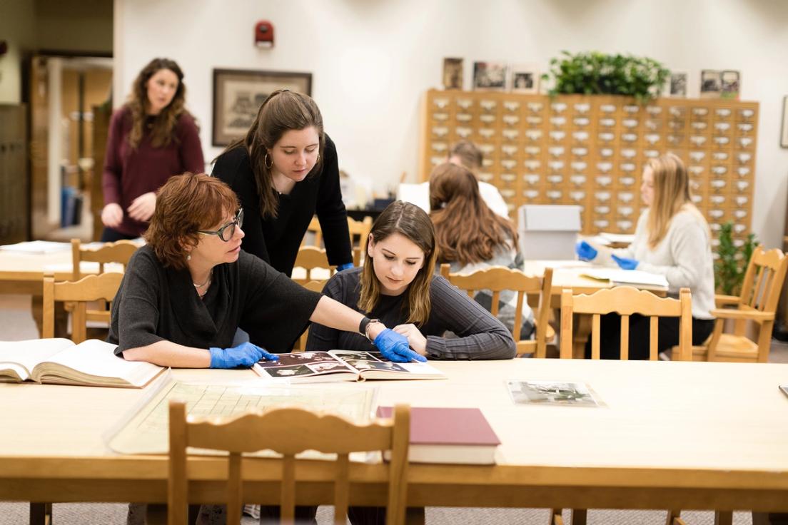 Claire Strom working alongside her students in the Rollins College Archives as they delve into the history of diversity and inclusion at the College.