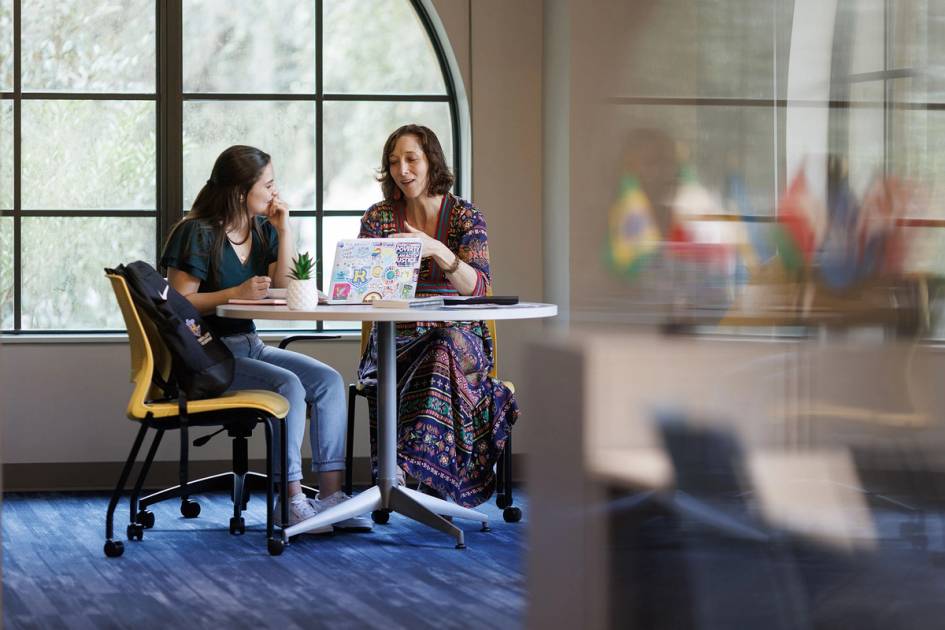 An advisor meets one on one with a college student.