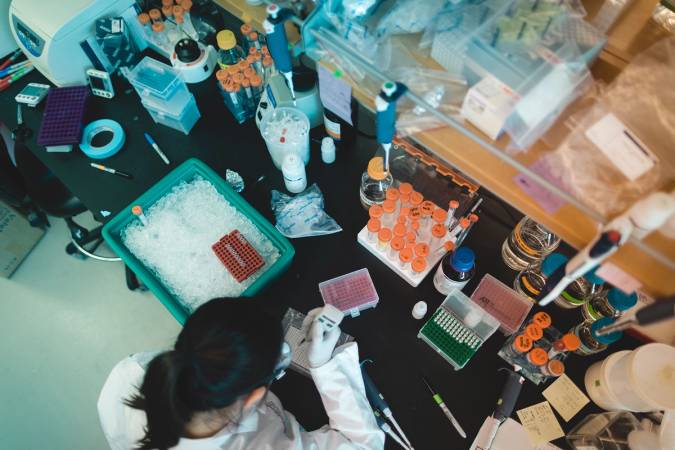 Student testing samples in a lab. 