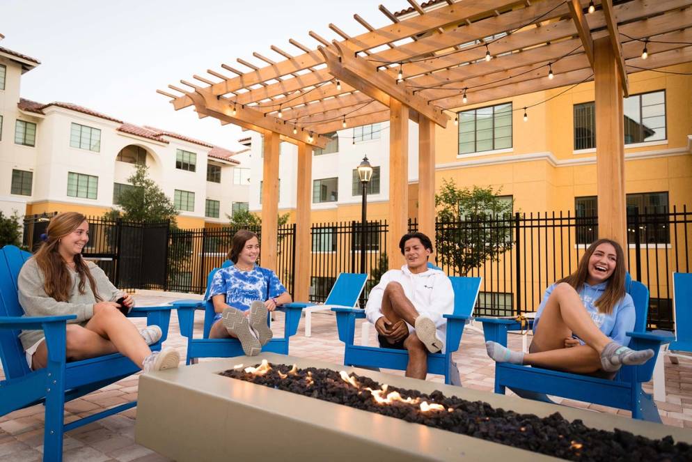 Student gather around a fire pit at Lakeside Neighborhood