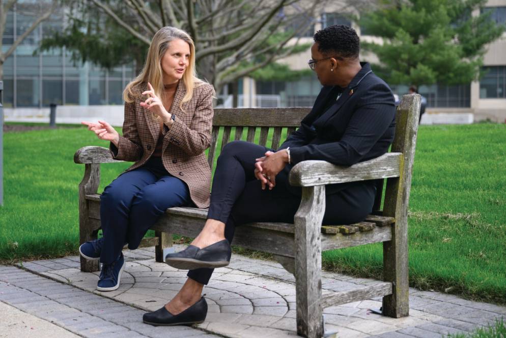 Brooke Barnett meets with a colleague on a bench at Butler University