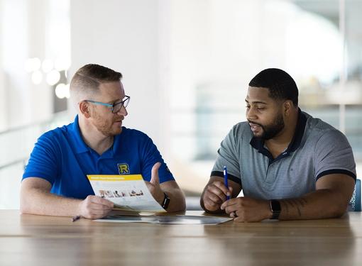 An admission counselor meets one on one with a prospective student.