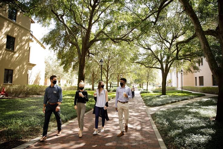 Crummer Graduate of Business School students walking on campus.