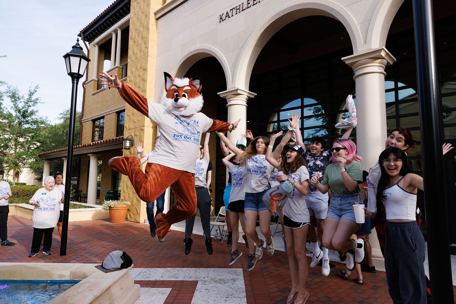 Fox Day 2023, a group of students and the fox jumping in the air