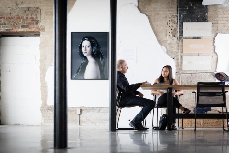 A student intern meets with the gallery director at Snap! Orlando