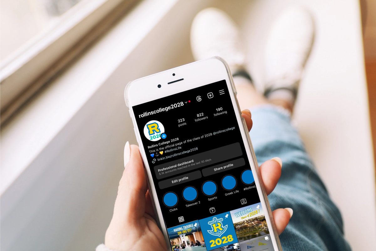 A student scrolls through the Rollins Class of 2028 Instagram group.