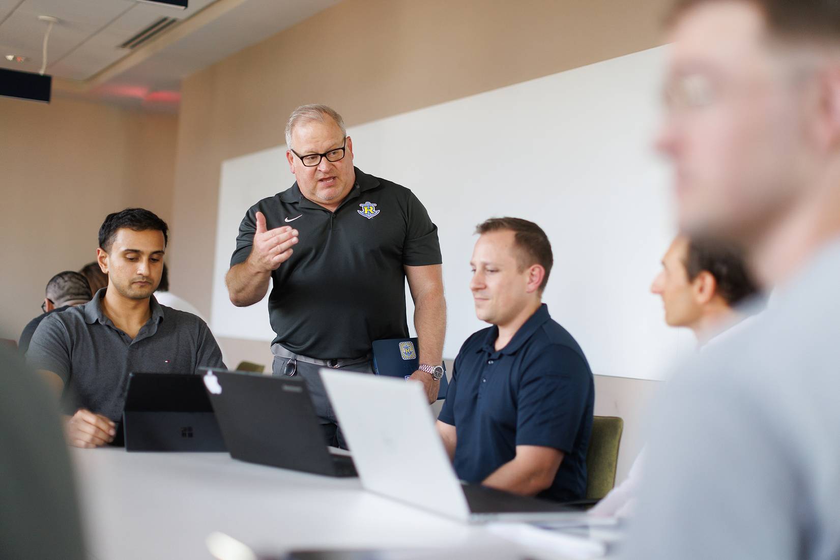 A business professor works with a small group of students at Rollins College.