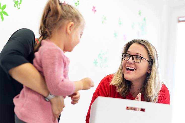 A community health advocate works with a young child.