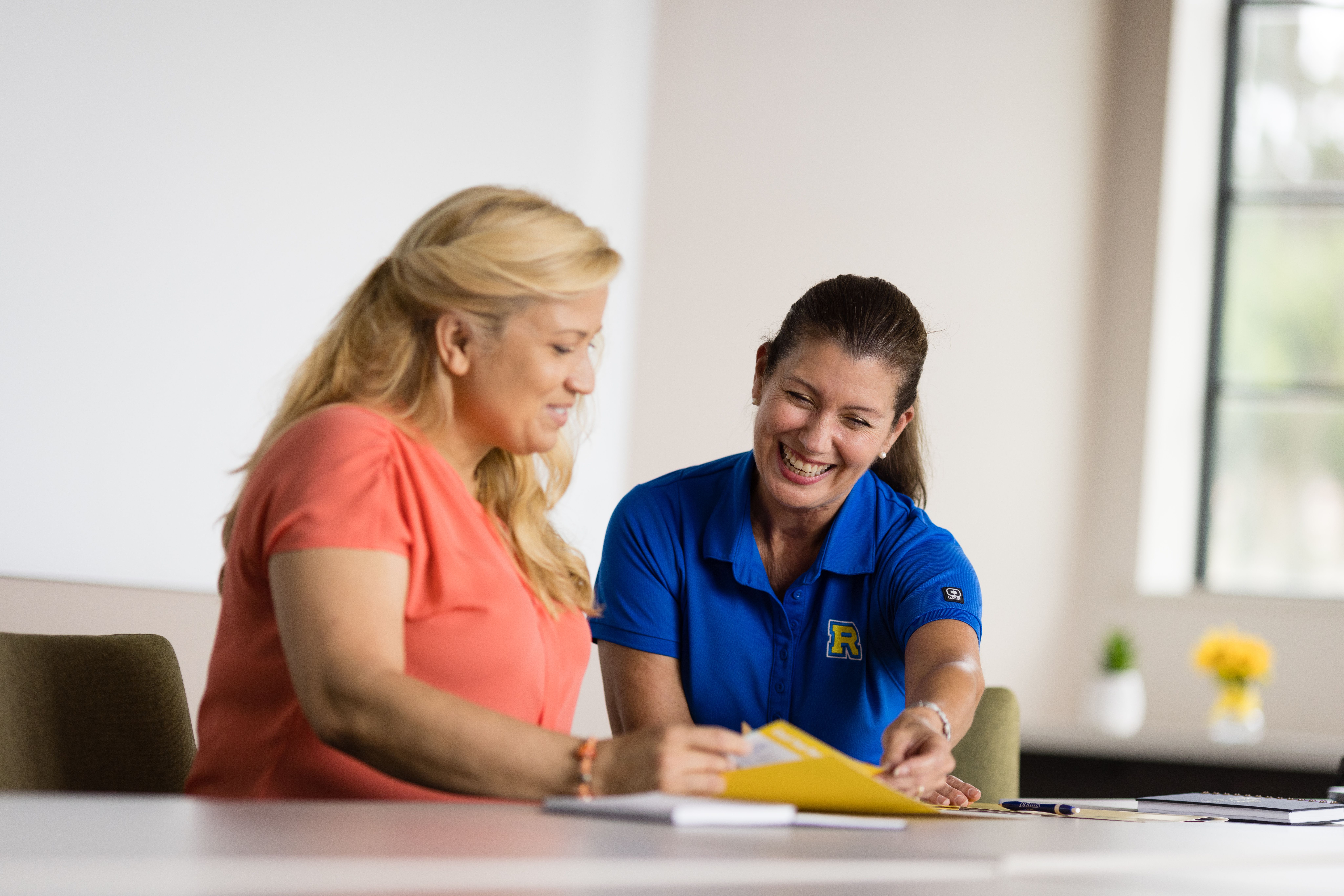  Two women working at a table. 