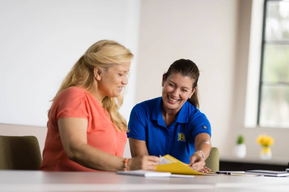  Two women working at a table. 