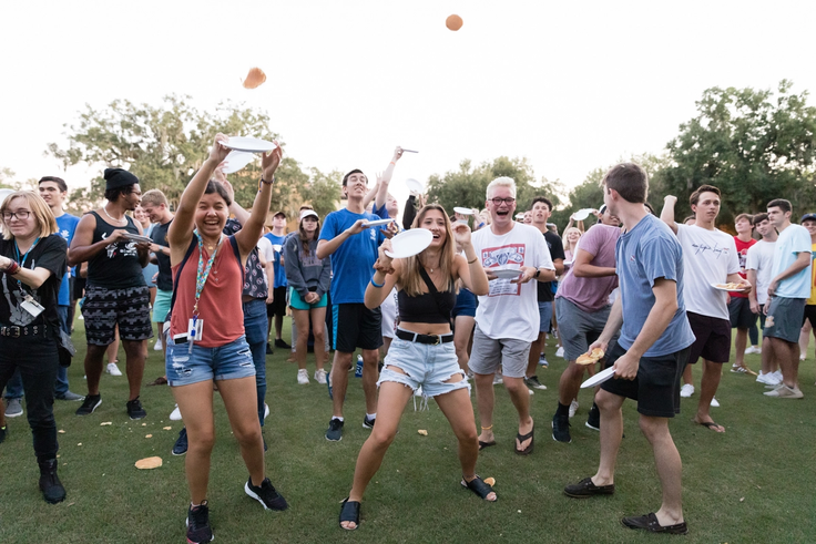 Students attempt to catch pancakes during the pancake flip, one of Rollins’ most beloved traditions during orientation week.