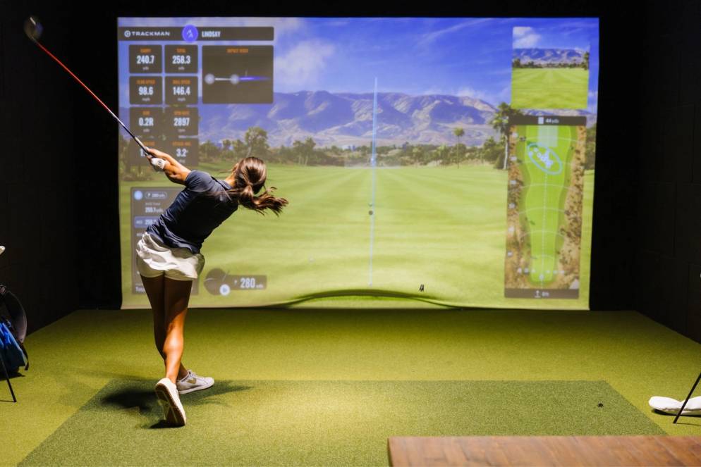 Student-athlete using the golf simulator