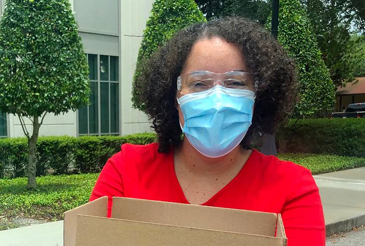Riley Hoffer ’20 distributes PPE as part of her summer internship during the COVID-19 pandemic.