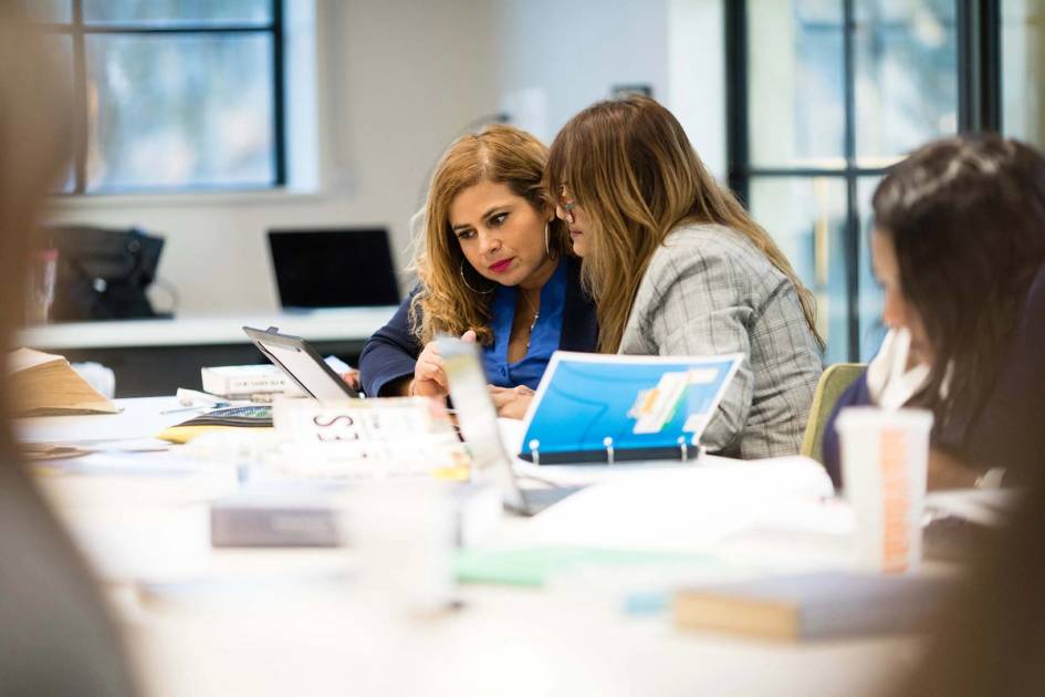 Two education students work on an assignment together in class.