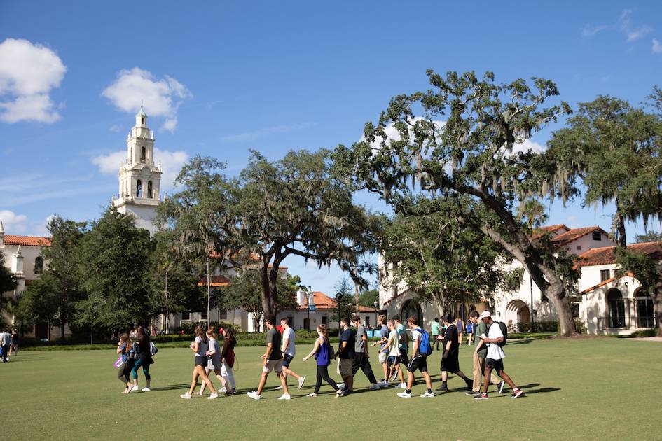 Students walking across Rollins campus during a camp