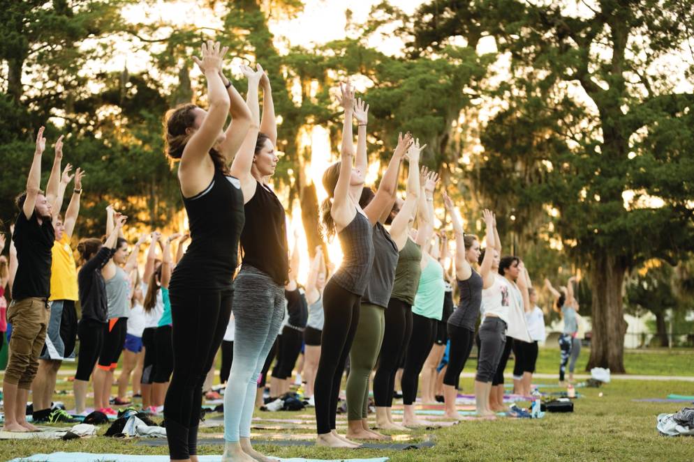 Students participating in yoga on the lawn