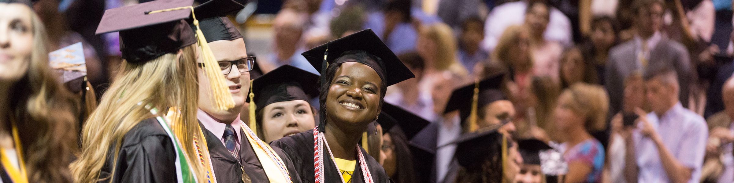 Graduate smiling during graduation ceremony. 