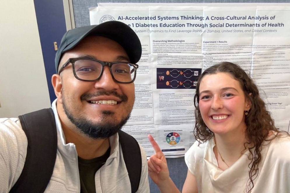 Lauren Barry ’24 with business professor Raghabendra KC ’13 in front of her thesis presentation