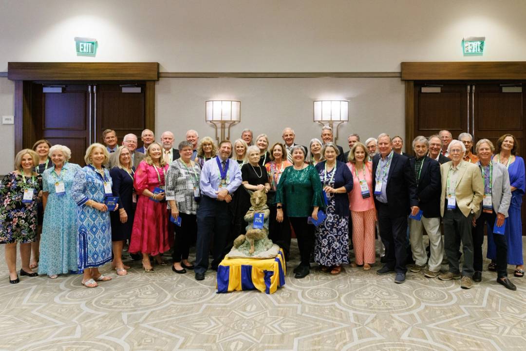 Rollins Alumni Weekend 50th Reunion, Order of the Fox Induction Reception where alumni pose with the Rollins fox statue.