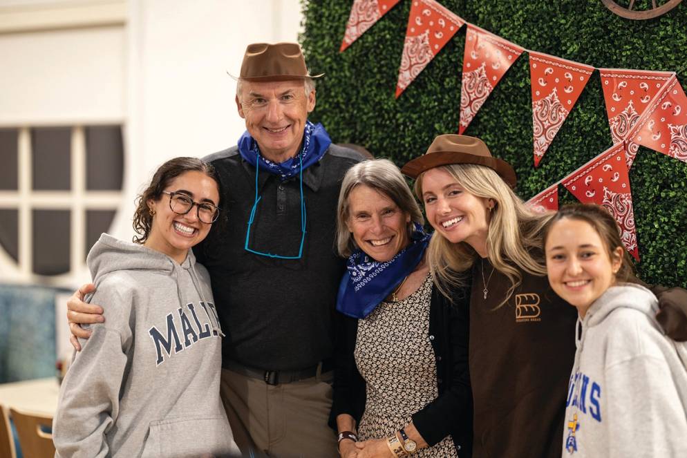 Grant and Peg Cornwell and students during pancake breakfast on campus