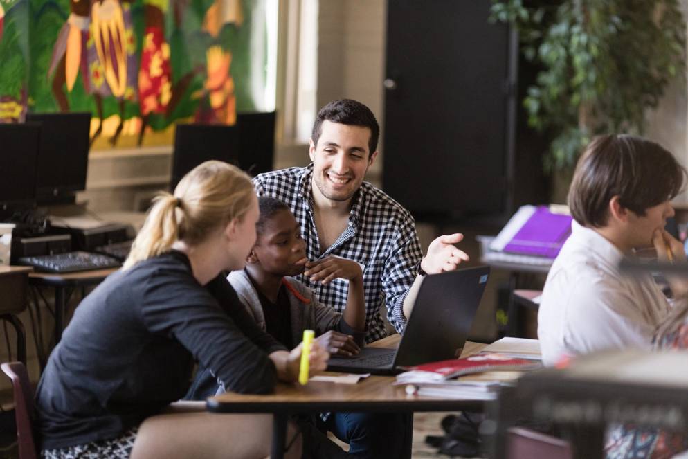 Sam Sadeh teaches local schoolchildren the basics of coding.