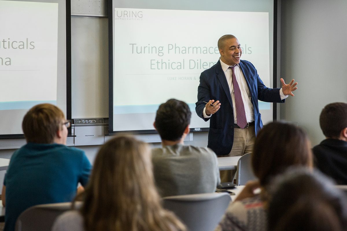 A business professor leads a class discussion.