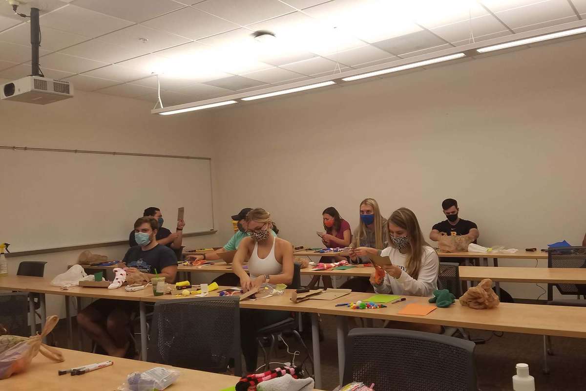 Students participate in a puppet making workshop with professor Sarah Parsloe