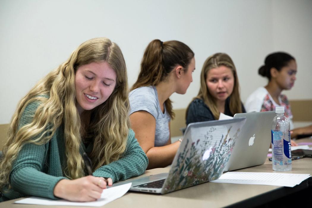 Rollins sociology students working together on a group project.