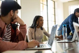 Rollins students have a round-table discussion in a classroom in Kathleen W. Rollins Hall.