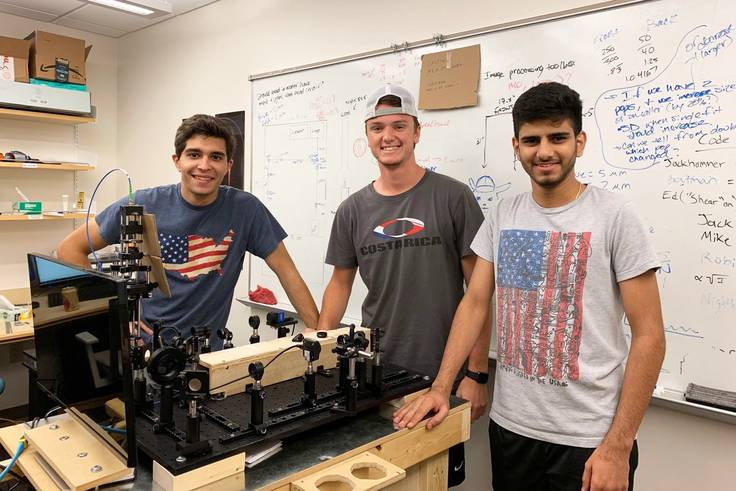 Raj Singh studies in the physics lab with two fellow students.