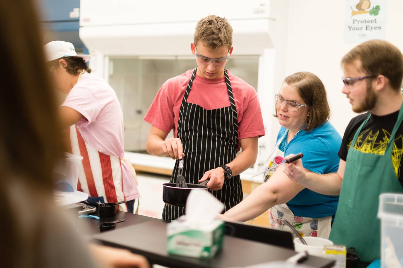 Students prepare gelatin during a chemistry experiment.