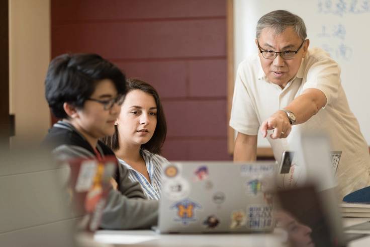 Karina Barbesino ’19 and professor Li Wei work together on a laptop.