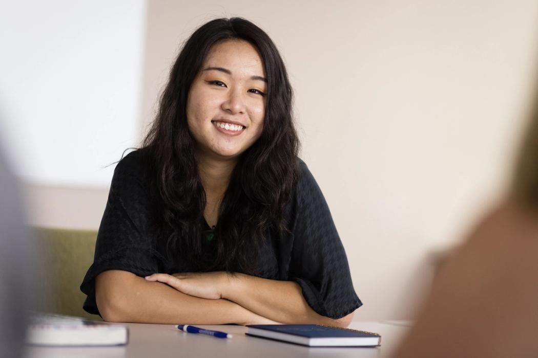 A female college student smiles at the camera.