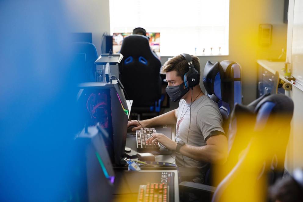 Student playing a video game in Rollins’ esports room.