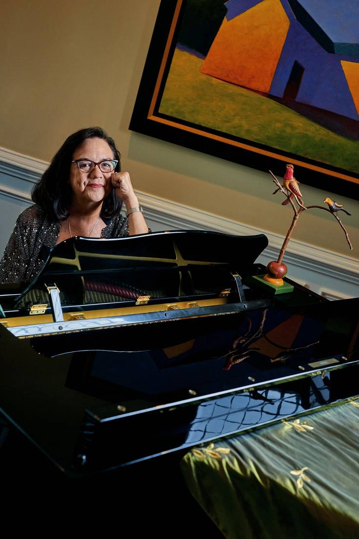 Sally Albrecht ’76 seated at the piano.