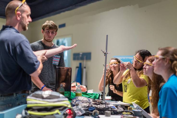 Students learning about weights and measures during a physics class.