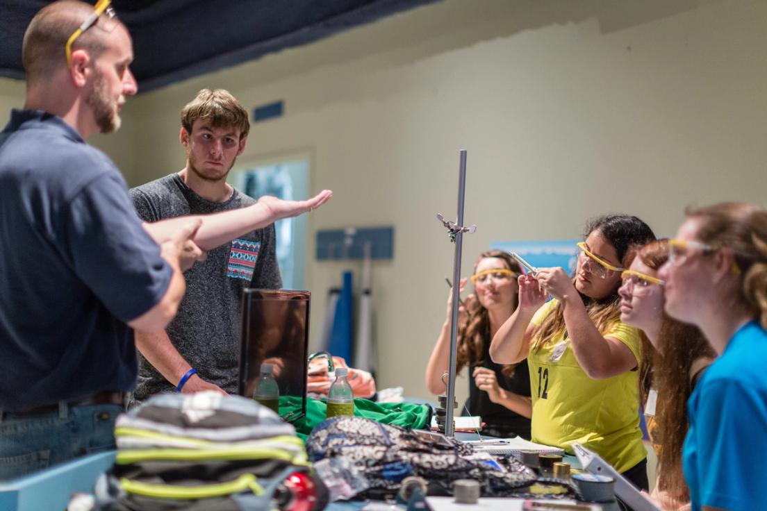 Students learning about weights and measures during a physics class.