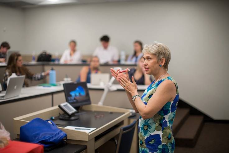 An economics professor leads a class discussion.