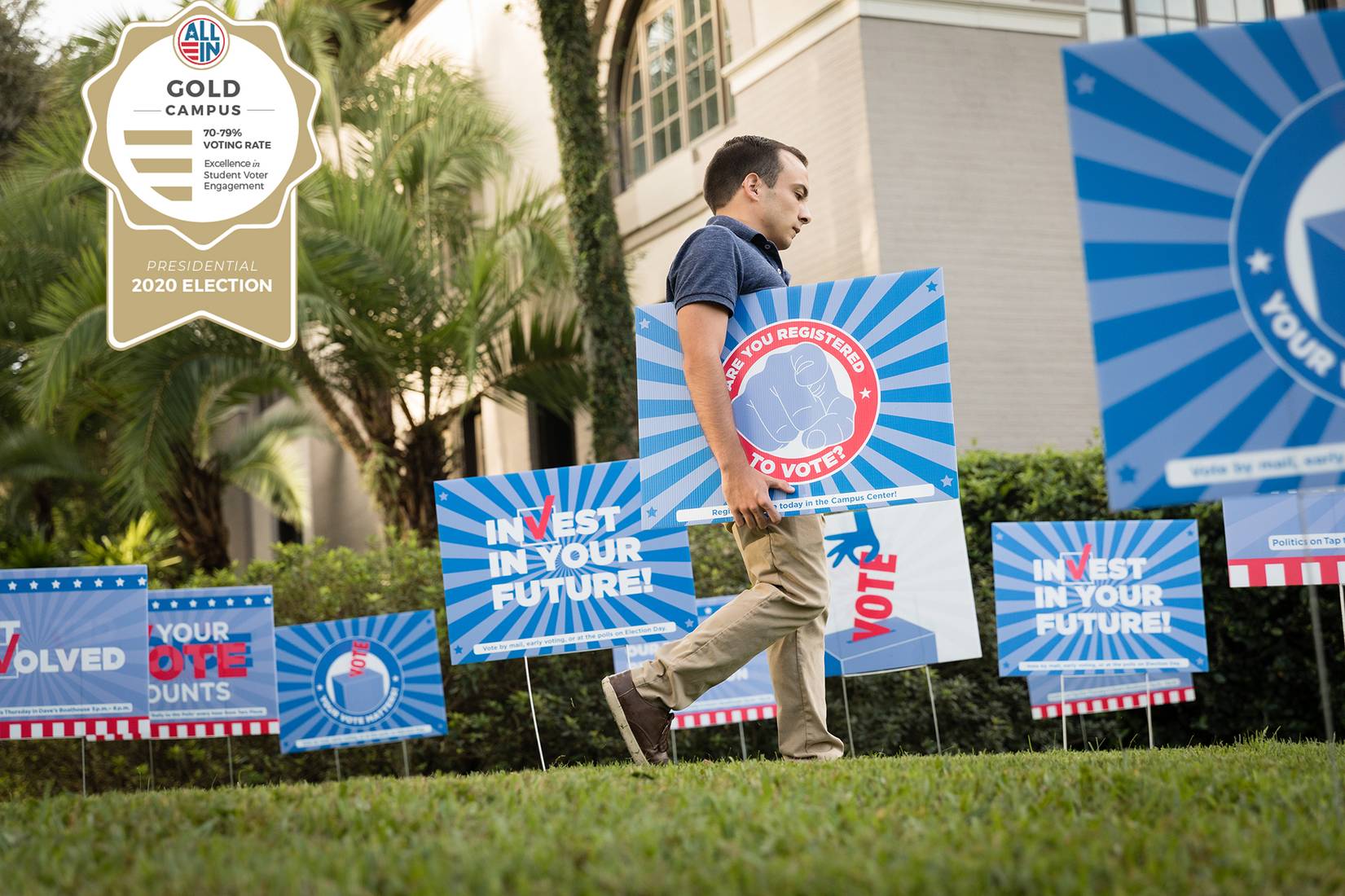 Skylar Knight places voting signs on campus.