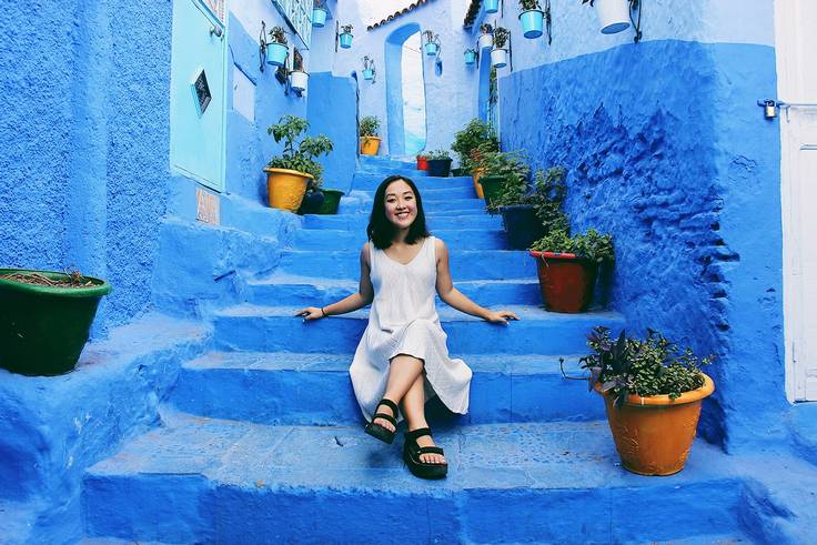 Renee Sang pictured on bright-blue steps in Morocco during her internship with Morocco World News.