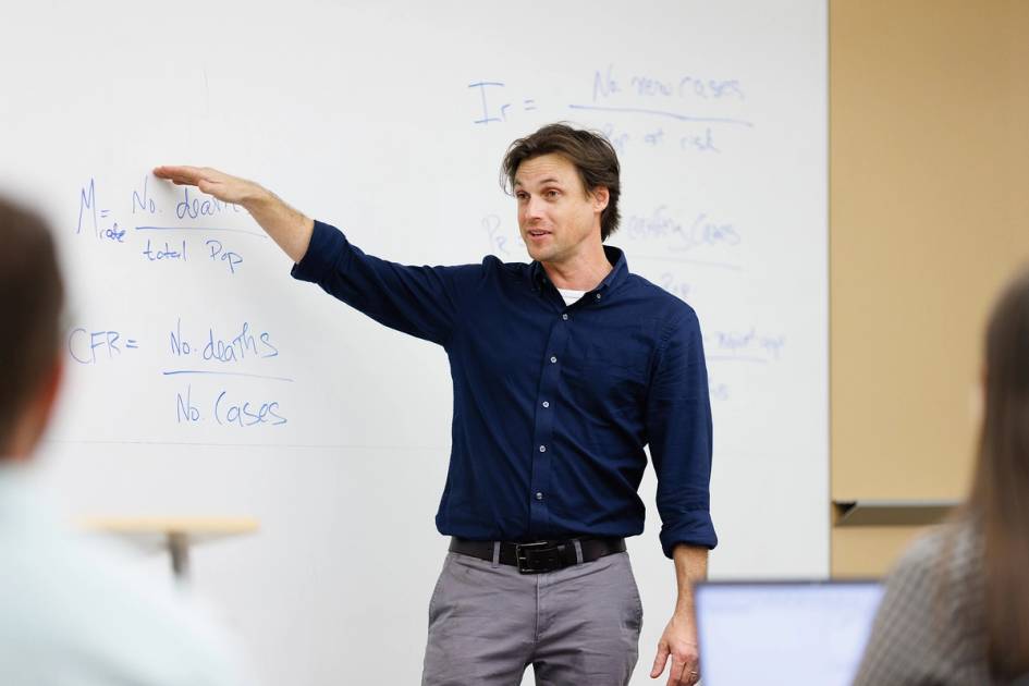 A professor explains a public health concept to a class of students.