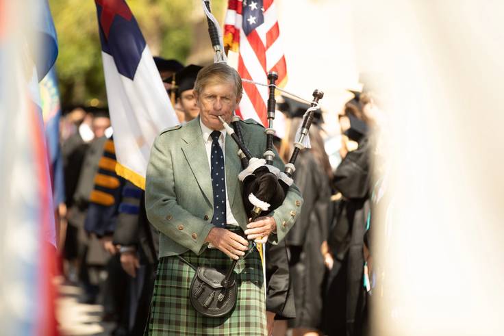 A musician plays bagpipes.