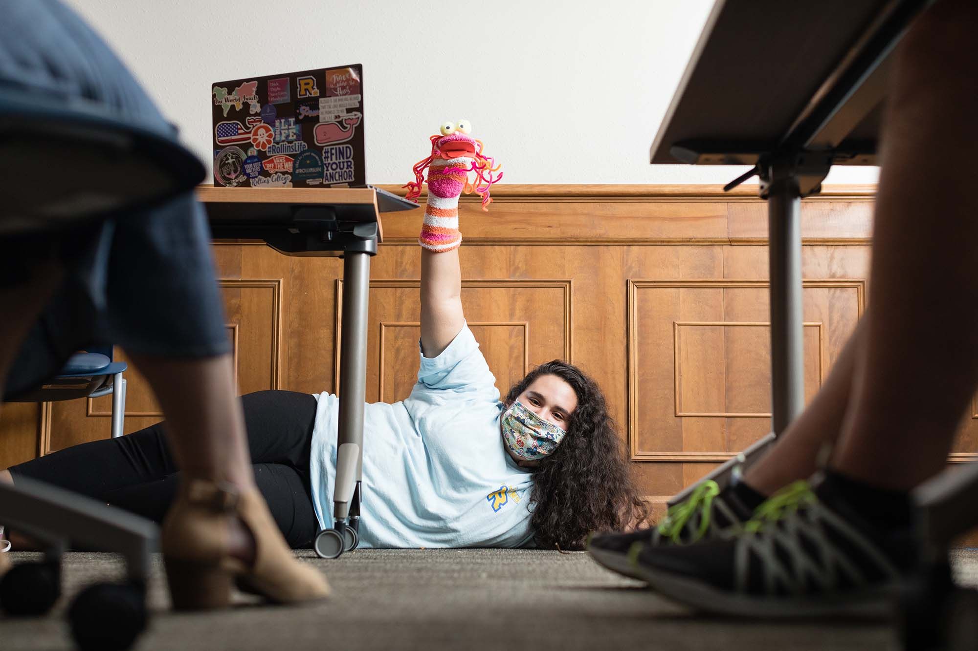 A student holds a sock puppet up during a digital puppet making workshop