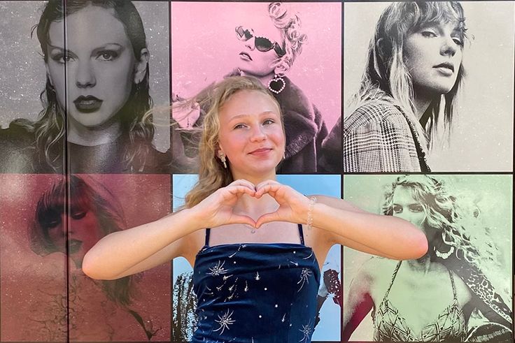 Ella Hutsell posing in front of a mural of Taylor Swift
